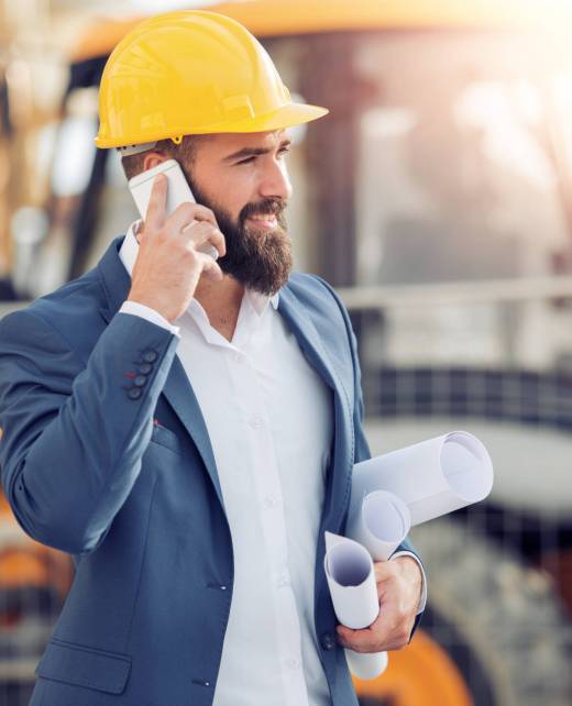 Businessman in hardhat talking on phone.Business,people,industry ans success concept.